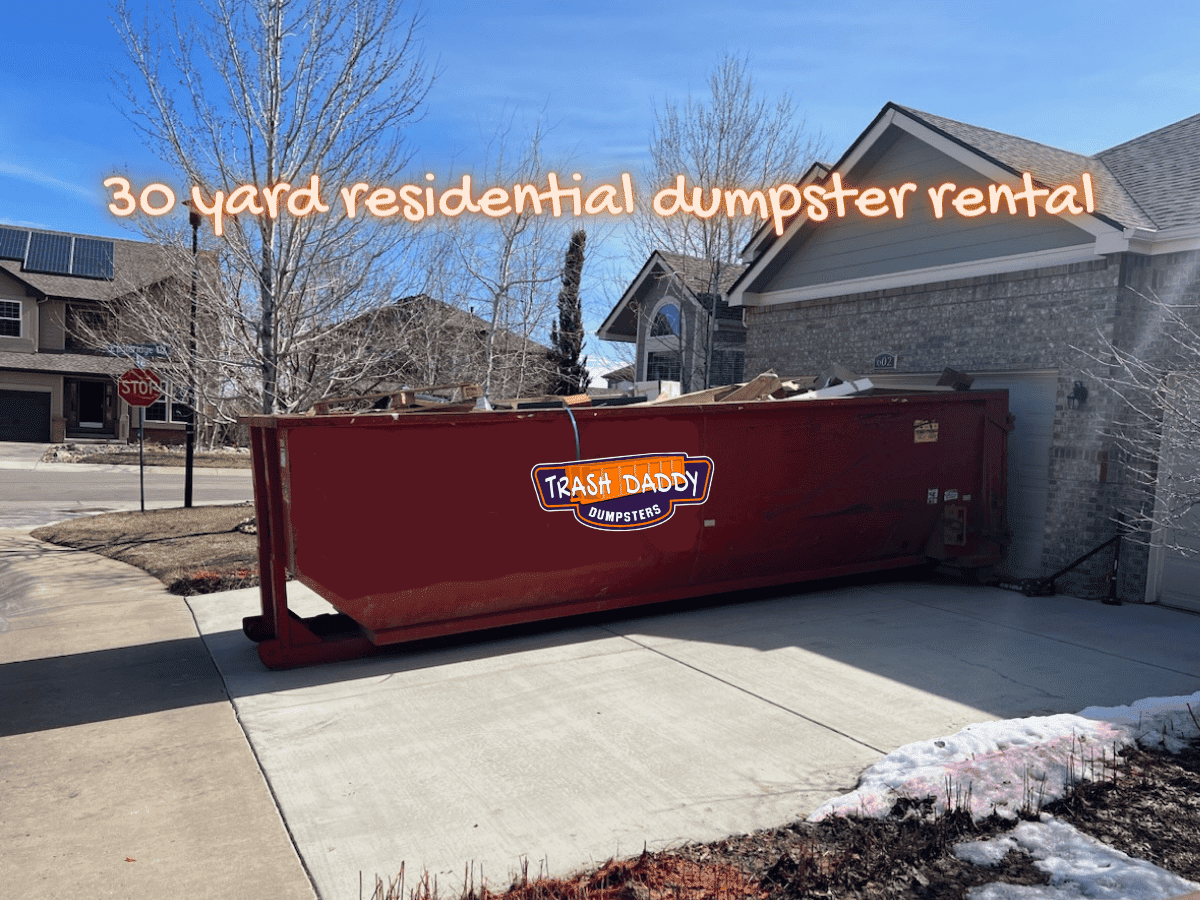 red 30 yard dumpster in a driveway